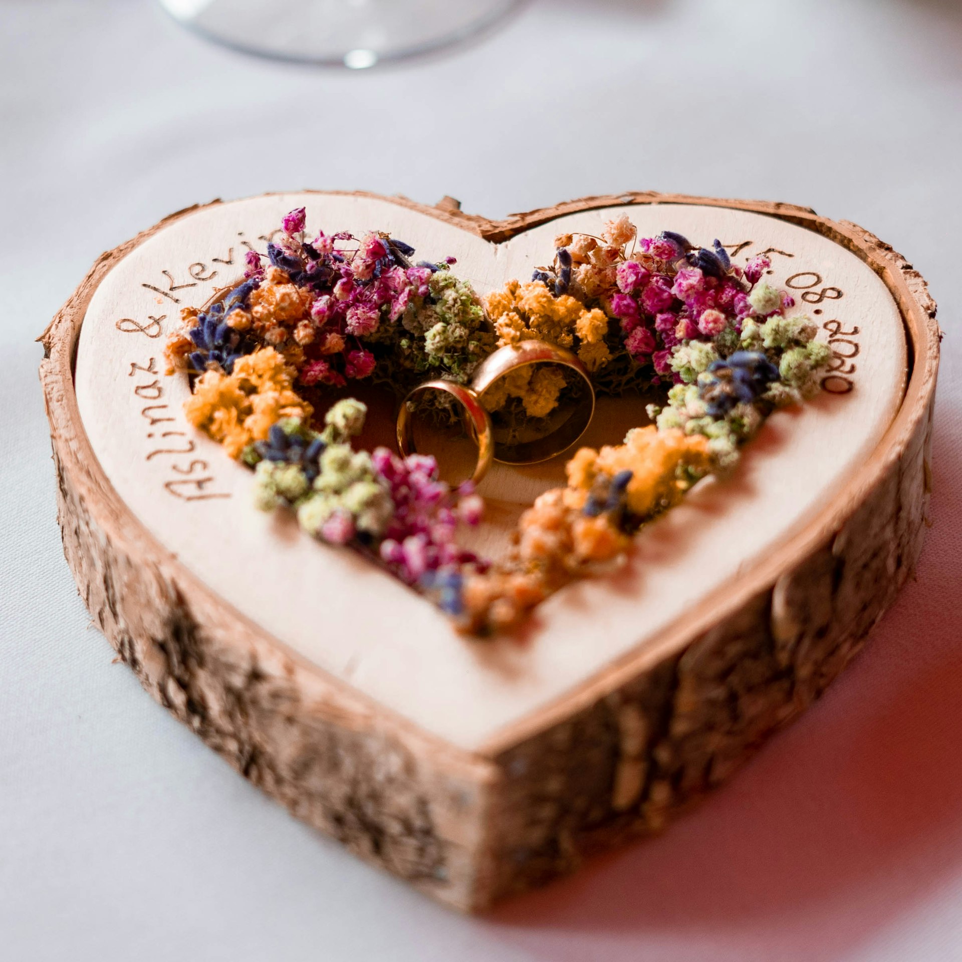 gold wedding band on white and brown cake